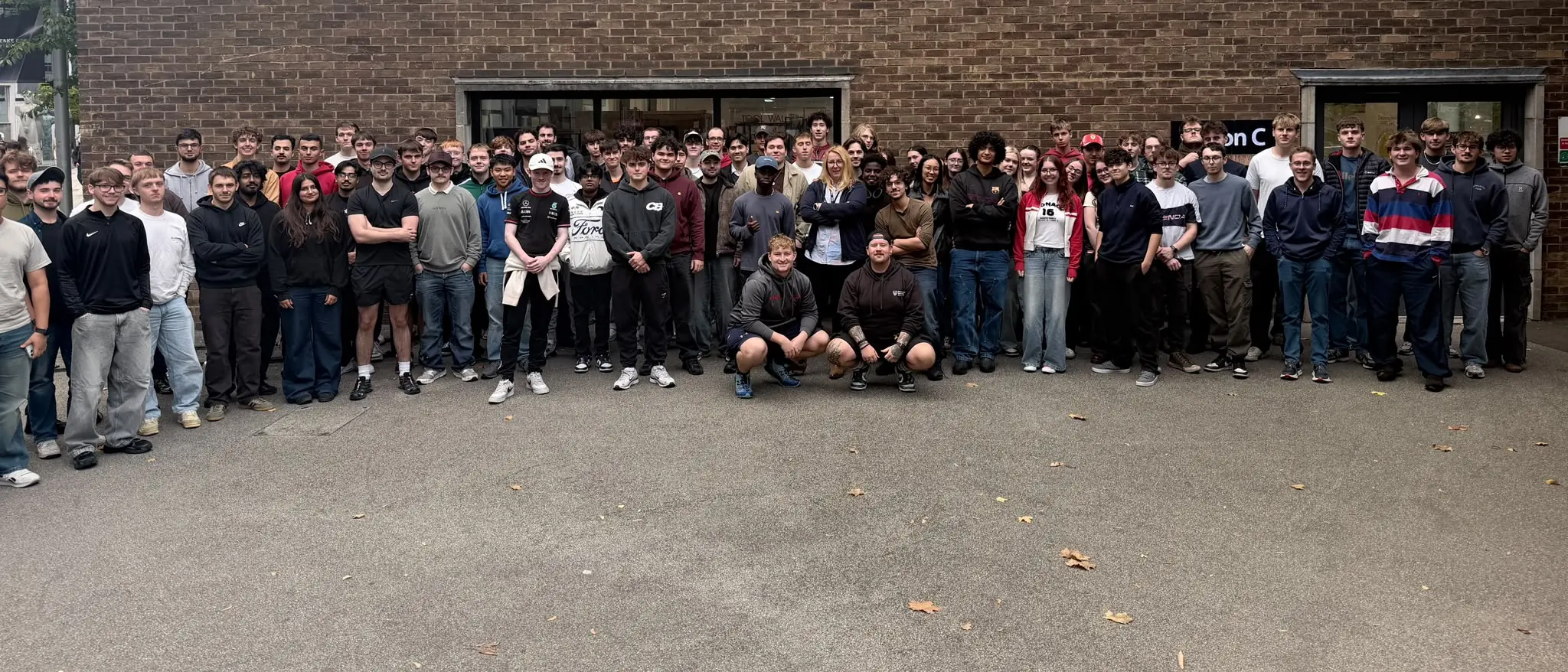 Around a hundred NUFS Racing members standing together outside a Northumbria University building
